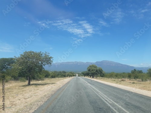 Road in the dessert of south africa with the drakensmountians in the background. 