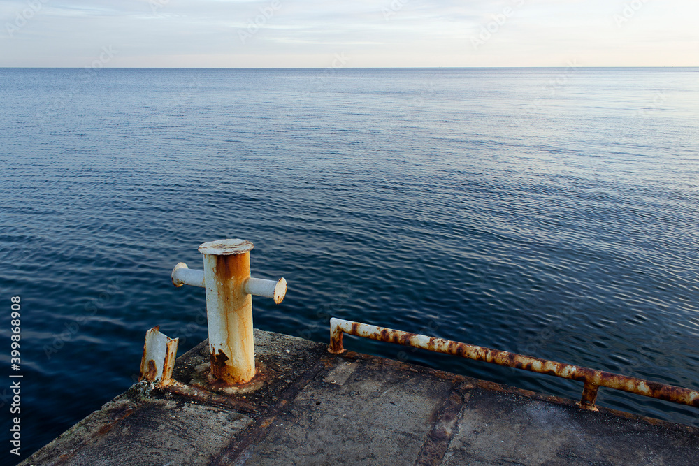 Old stone boat pier with panoramic blue sea water view shipping trade concept 