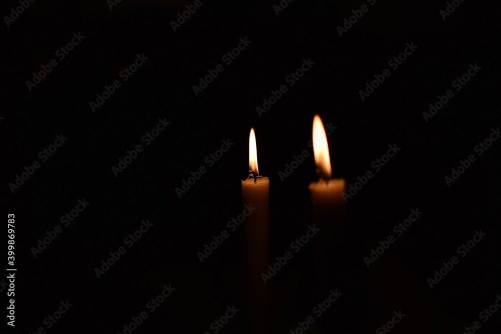 Burning candles in the dark with black background Burning candles in the dark with black background