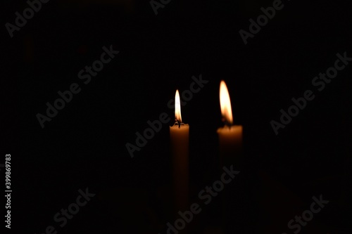 Burning candles in the dark with black background