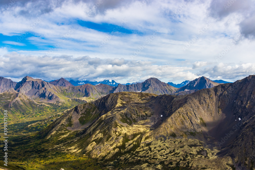View of the Chugach mountains as seen from the summit of Ship Lake Pass above Hidden Valley, near Anchorage, Alaska. The landscape is above the treeline, and hence is covered in alpine tundra.