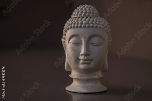 Sculpture of a bust of a Buddha. Eastern god in Buddhism. India and Sri Lanka beliefs © subjob