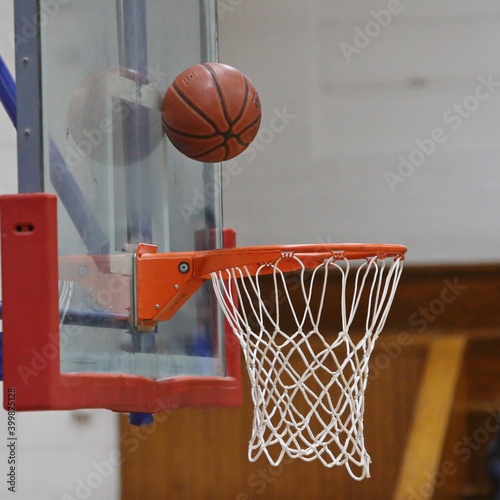 Basketball bouncing against backboard for the score © SBaty