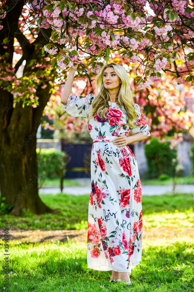 Wonderful smell. summer weather and nature. woman with long hair in park. pink cherry tree blossom. beautiful woman in dress. girl with blooming sakura tree. spring fashion style. real female beauty Wonderful smell. summer weather and nature. woman with long hair in park. pink cherry tree blossom. beautiful woman in dress. girl with blooming sakura tree. spring fashion style. real female beauty