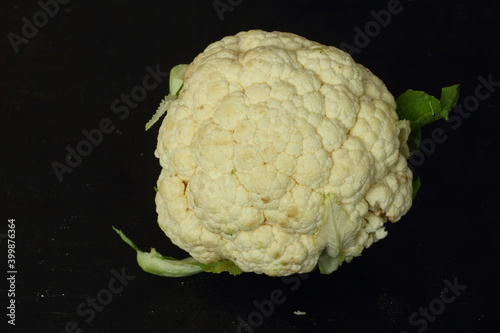 Raw cauliflower, whole vegetable. Fresh cauliflower isolated on black background.
