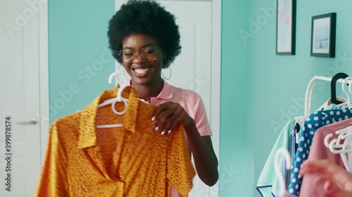 Young stylish women, Afro-American and Caucasian white, are getting ready to a party, choosing dresses, having fun, anticipating great evening, Foreground, Slow motion.