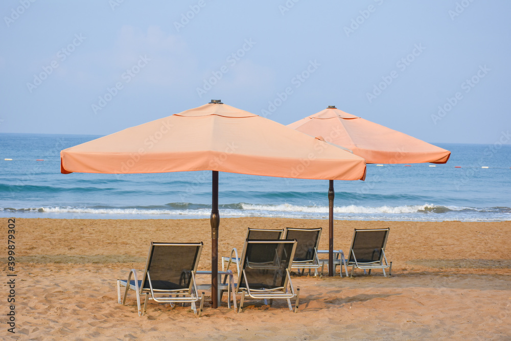 Beautiful umbrella and chair near The Mediterranean Sea in hotel. Resort - vacation concept. Summer holidays. Sand on the beach. Empty beach.