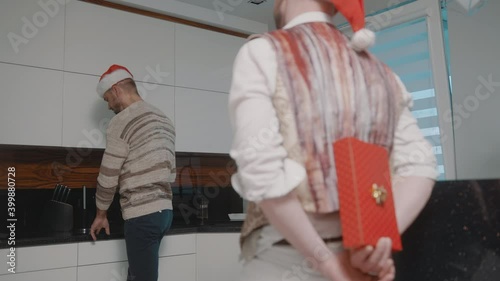 Man giving surprise gift to his husband. Gay family and christmas eve celebration. winter holidays. High quality 4k footage photo