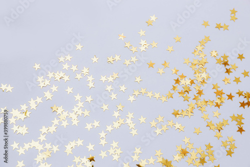 Holiday background with little golden stars on gray background. Template for greeting card, text design