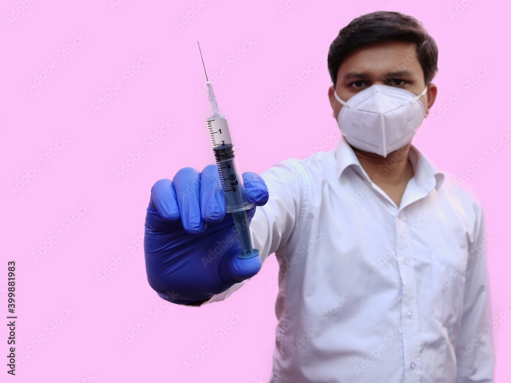 Man hold Syringe injection for corona virus vaccine concept on pink background Man hold Syringe injection for corona virus vaccine concept on pink background