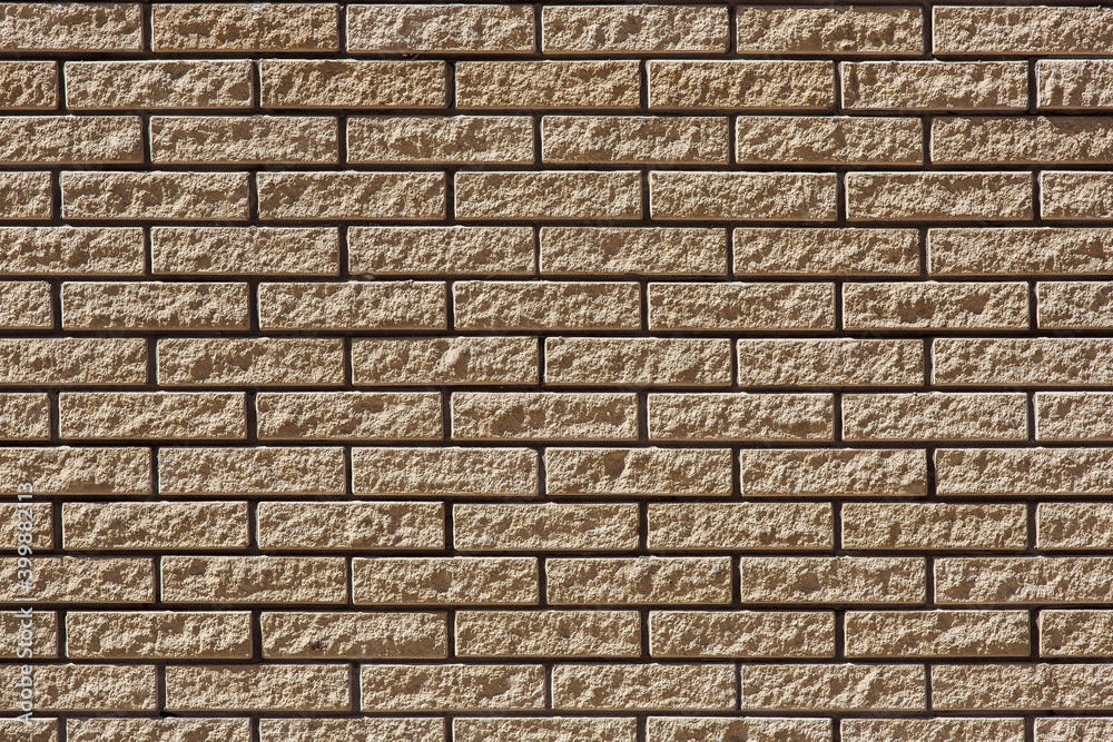 brick facade of beige wall, stone building texture, closeup nobody.