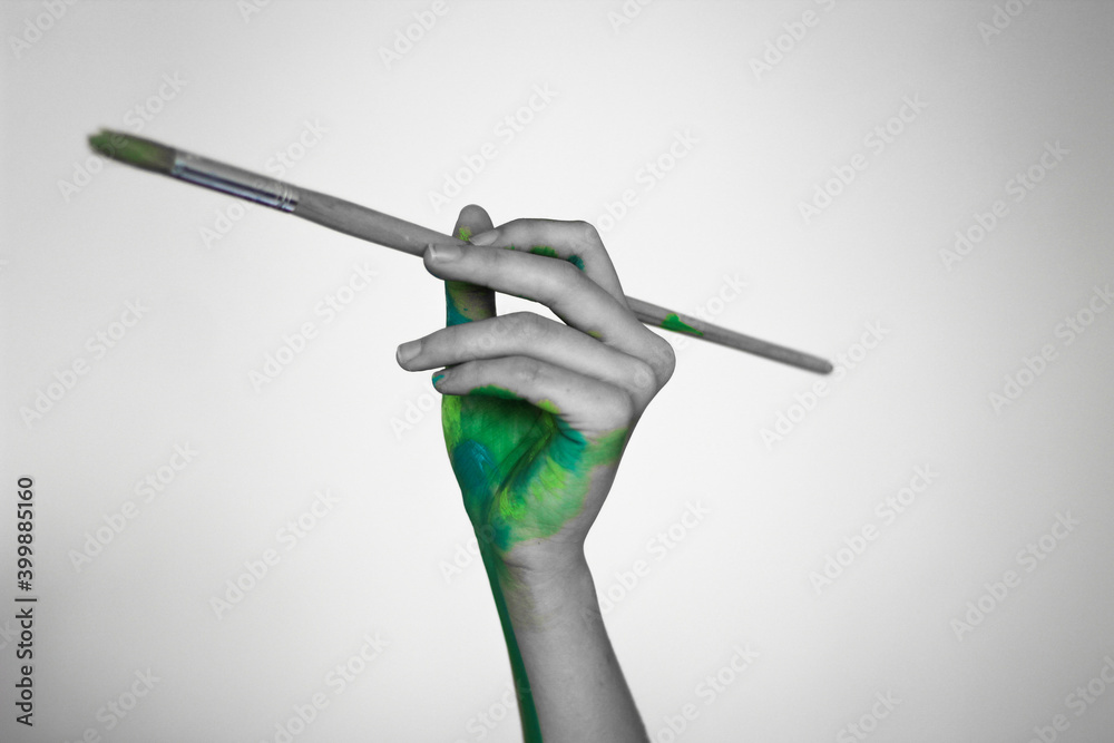 Fototapeta premium hand with a paintbrush 