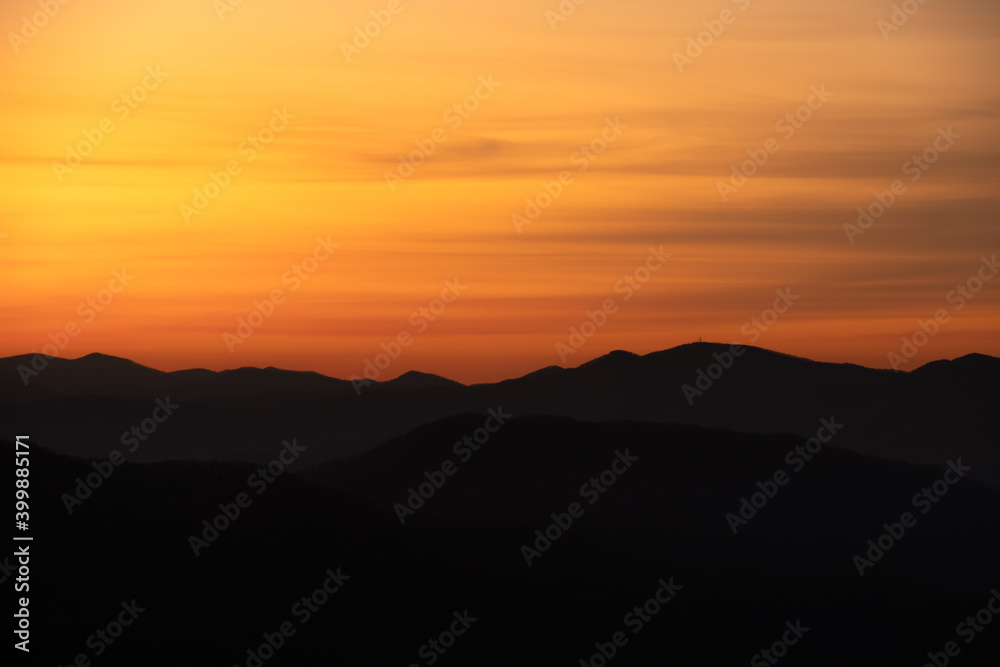 Yellow and Orange Smear Over Mountain Ridge Silhouette
