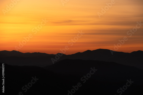 Yellow and Orange Smear Over Mountain Ridge Silhouette