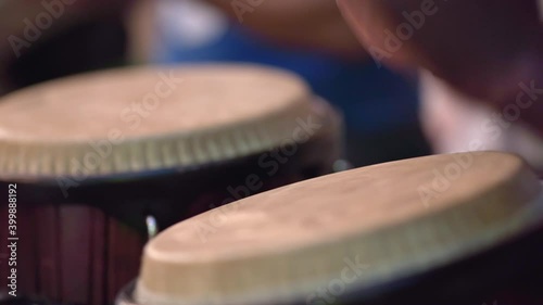 Close shot of man playing conga at street festival photo