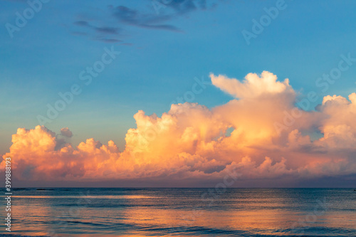 A beautiful sunrise with huge colorful clouds above the ocean in Mexico