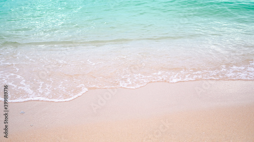 Sand beach with white sea soft wave on top view for assembling an article about travel in summer holiday or ocean coast nature.