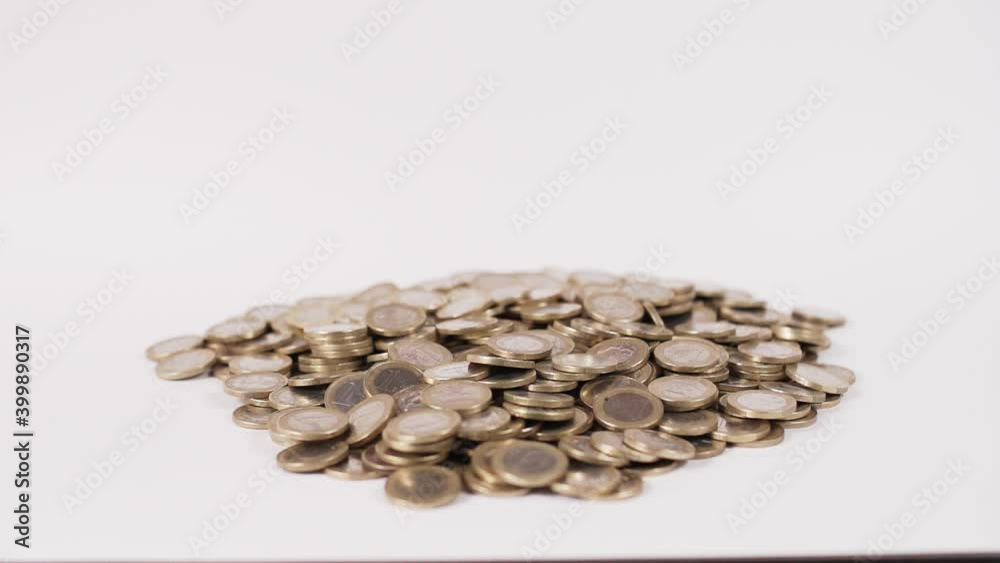 Euro Coins Falling And Building A Pile - slow motion, studio shot Euro Coins Falling And Building A Pile - slow motion, studio shot