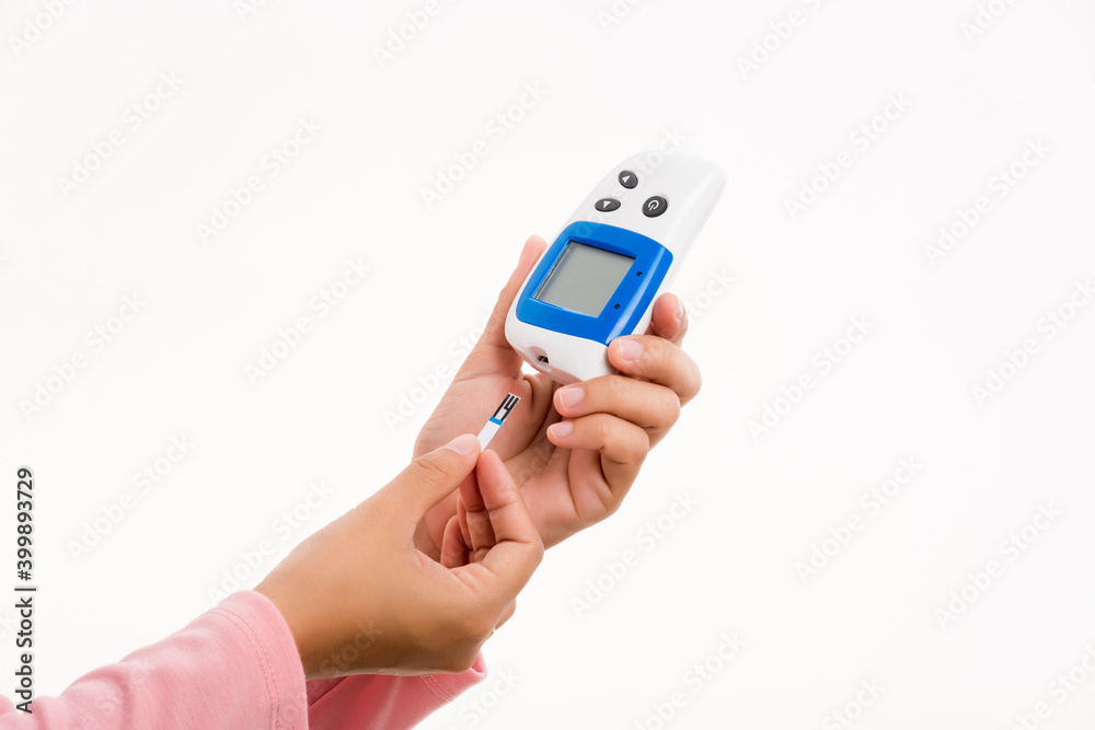 Closeup hand woman measuring glucose test level checking on finger by glucometer she monitor and control high blood sugar diabetes and glycemic health care medical concept isolated on white background Closeup hand woman measuring glucose test level checking on finger by glucometer she monitor and control high blood sugar diabetes and glycemic health care medical concept isolated on white background