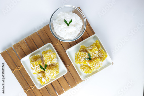 Ongol ongol ubi. Indonesia traditional cake that made from sweet potatoes. It's steamed and wraped with grated coconut after cooked photo