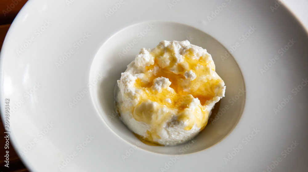 Traditional Catalan dessert - fresh cheese Mato with honey