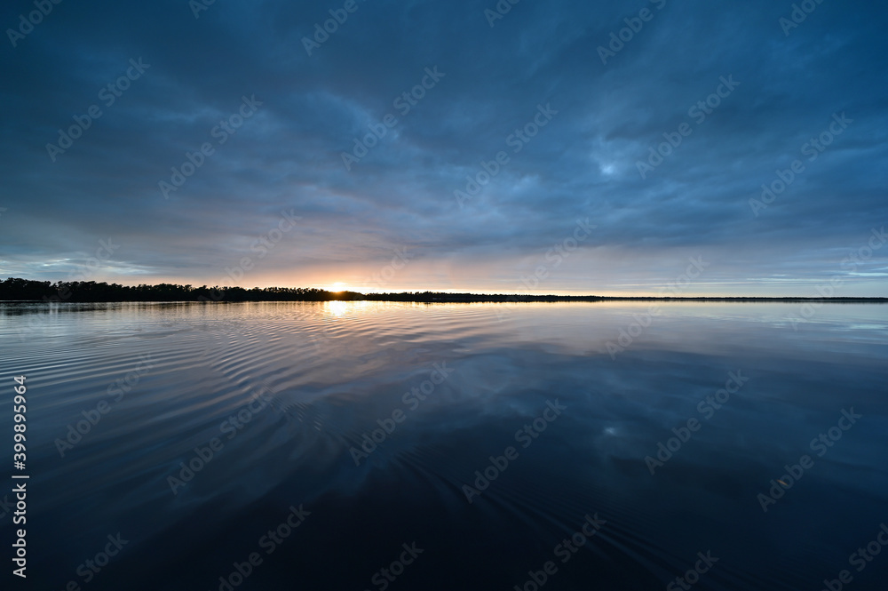 Winter cloudscape reflected in tranquil water of Coot Bay in Everglades National Park in late afternoon. - obrazy, fototapety, plakaty 