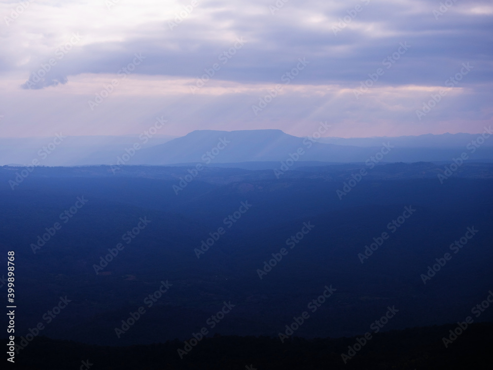 Cold tone sunset sky wide mountain landscape at Pha Yieb Mek in Phu Kradueng National park. Thailand.