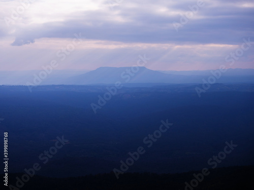Cold tone sunset sky wide mountain landscape at Pha Yieb Mek in Phu Kradueng National park. Thailand.