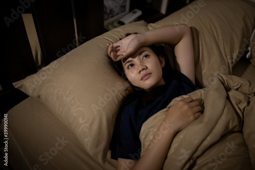 Young asian woman cannot sleep insomnia late at night. Can't sleep. Sleep apnea or stress. Sleep disorder concept.