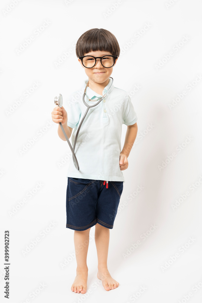 Asian boy with glasses smiling and plays stethoscope on white background. Asian boy with glasses smiling and plays stethoscope on white background.