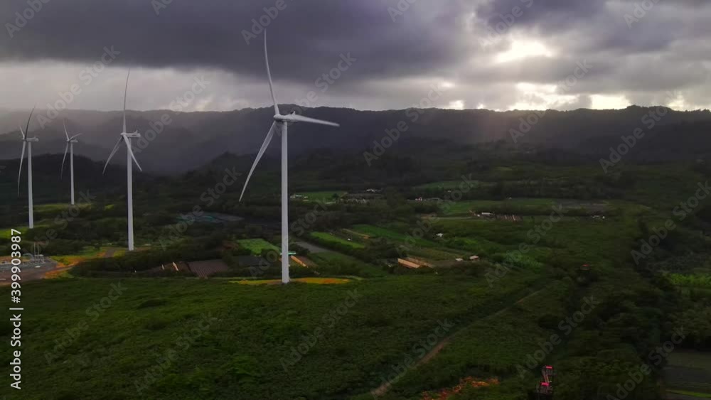 Windmills rotating in dramatic Hawaiian landscape and as stormy clouds pass by over head Windmills rotating in dramatic Hawaiian landscape and as stormy clouds pass by over head