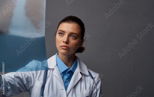 doctor in medical gown with x-ray on gray background research in laboratory