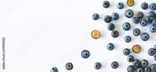 Blueberries scattered on white background banner