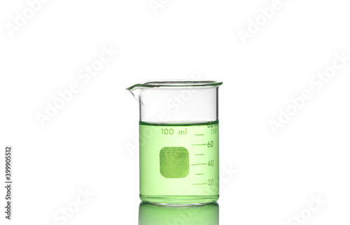 Fotografie Laboratory equipment, beaker filled by green liquid with reflection isolated on white background