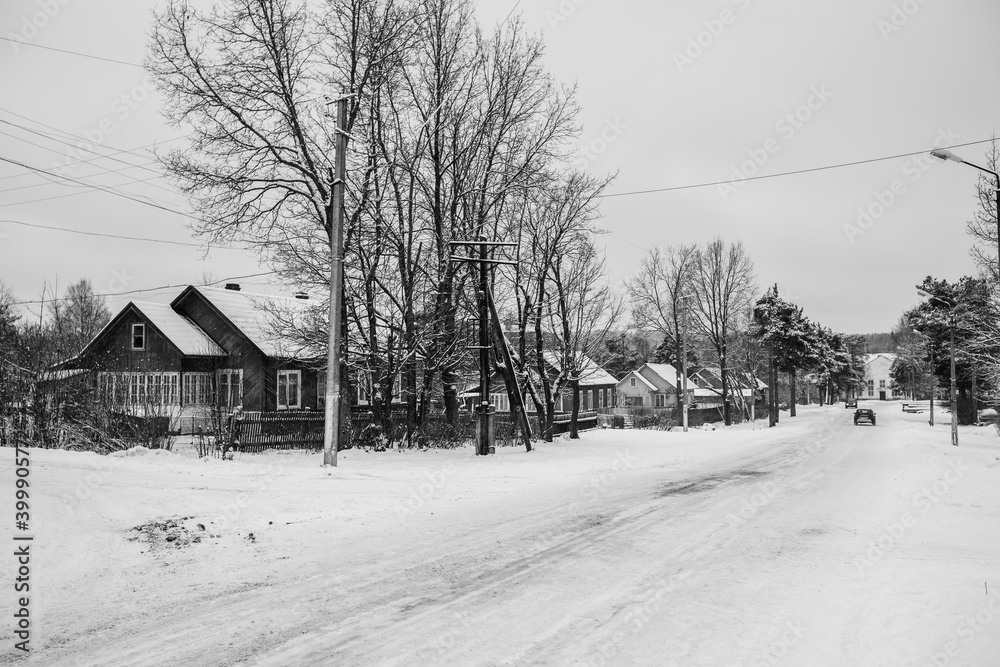Snowy rural landscape in the nord of Russia. Black and white photo.
