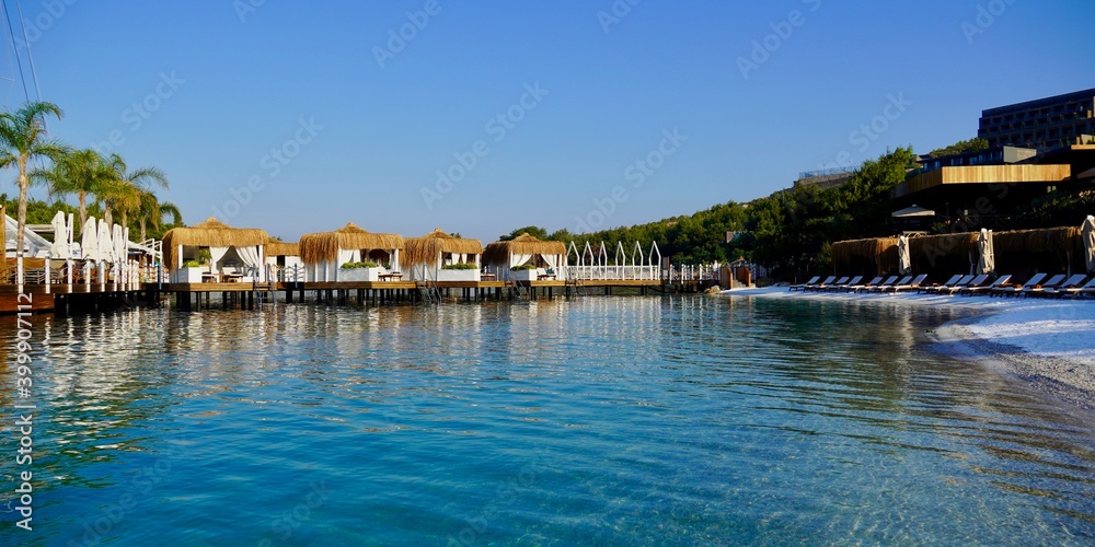 Panoramic view, View of nice empty sandy beach with some tropical bungalow. Banner, lots of copy space.