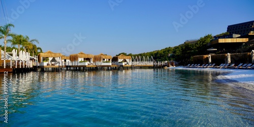 Panoramic view, View of nice empty sandy beach with some tropical bungalow. Banner, lots of copy space.