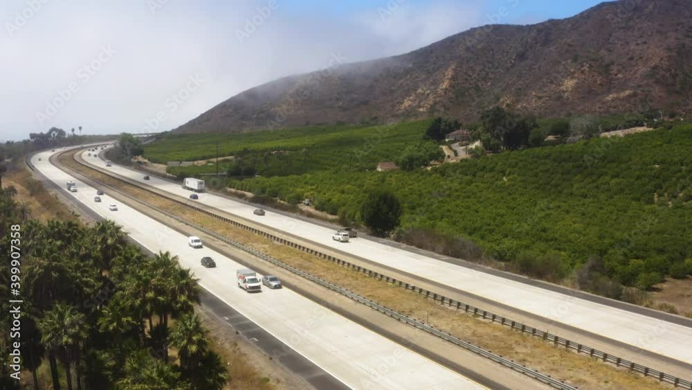 Cars and big trucks cruising down Freeway 101, southern California, surrounded by amazing landscape Cars and big trucks cruising down Freeway 101, southern California, surrounded by amazing landscape
