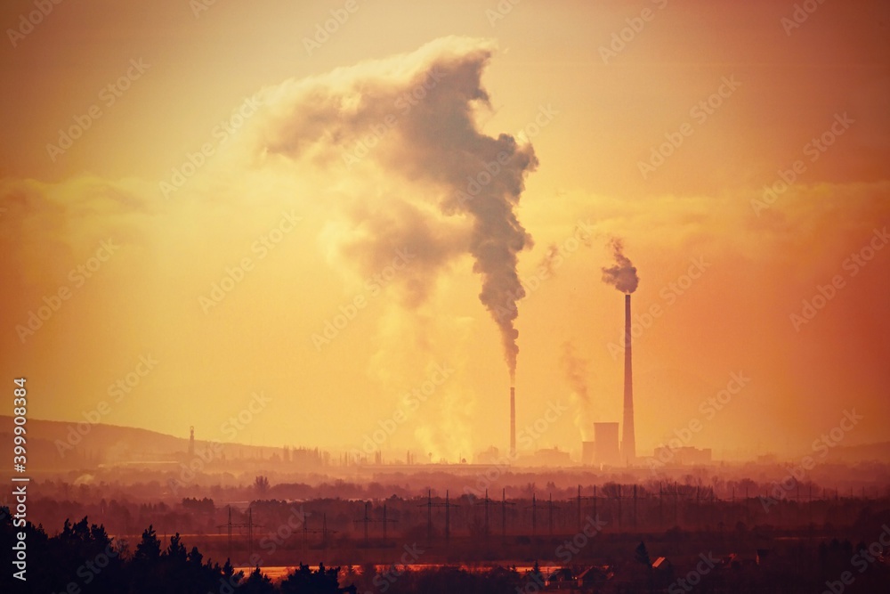 View from afar the city and a factory chimney with lots of smoke and smog.  Europe, landscape Slovakia, Novaky. Chemical factory. Abstract. Global warming of the earth.