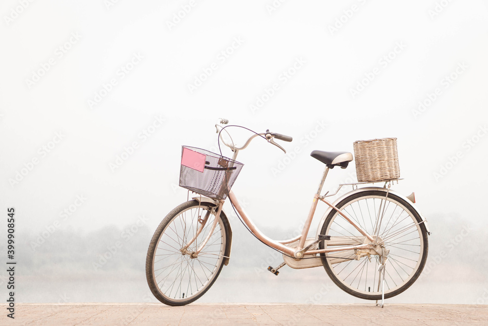 Fototapeta premium Red bicycle parked on the riverside on nature background.