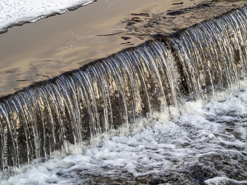 A small flat cascade in a calm river