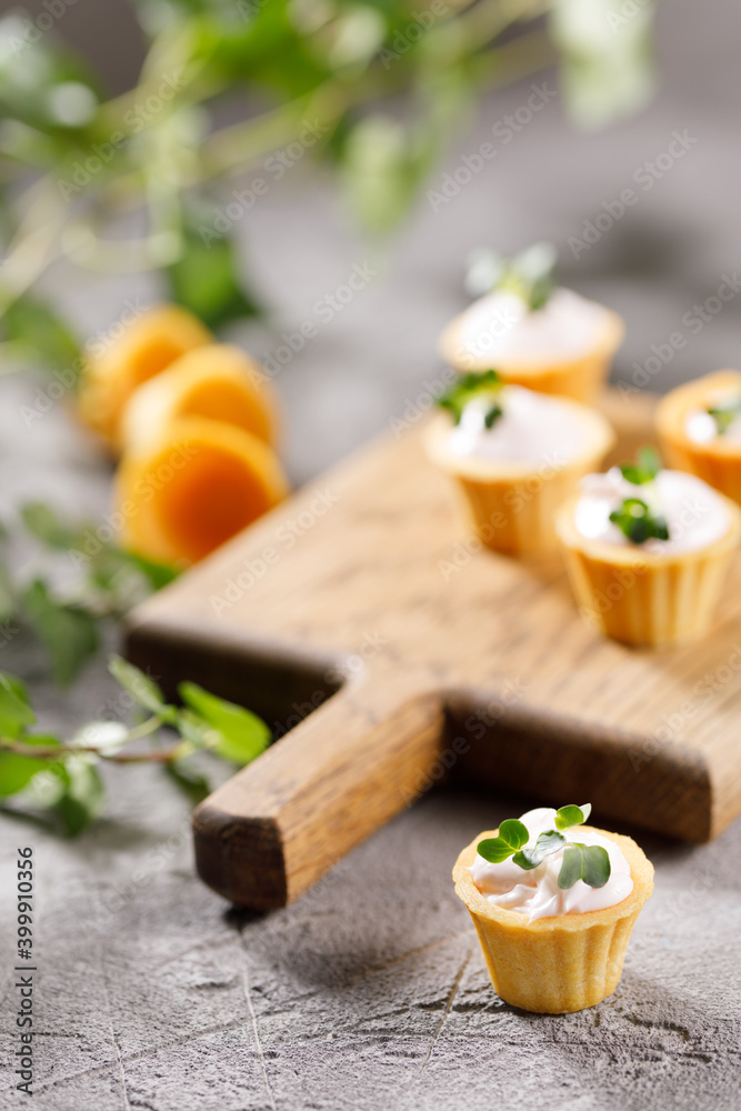 Canapes with light cream filling. Still life with microgreens. The concept of an appetizing snack. Canapes with light cream filling. Still life with microgreens. The concept of an appetizing snack.