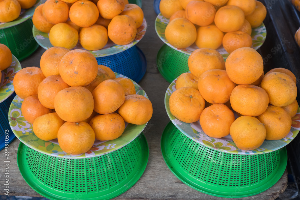 Basket of ripe citrus fruits displayed in a market ready to be bought and enjoyed