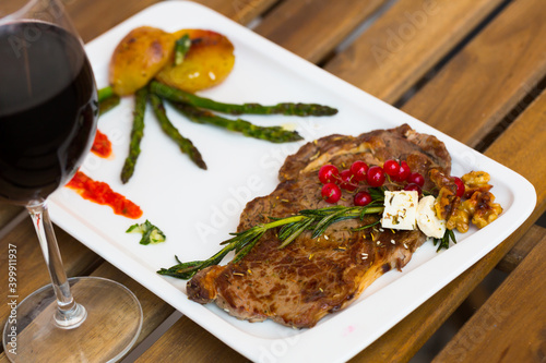 Fried veal cutlet with roasted vegetables decorated with fresh rosemary
