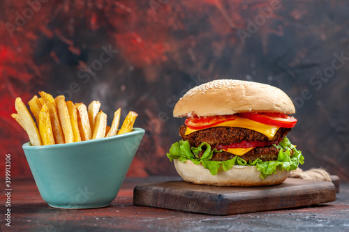 front view tasty meat burger with french fries on a dark background sandwich fast-food bun photo