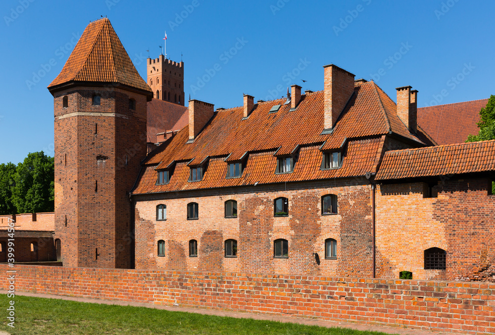 View of brick Gothic Castle of Teutonic Knights located in ancient Polish town of Malbork.