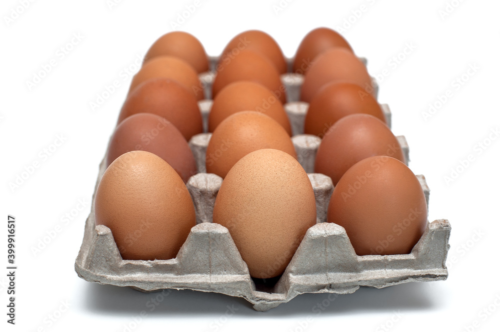 Brown raw chicken eggs in a cardboard box for eggs.Food background.