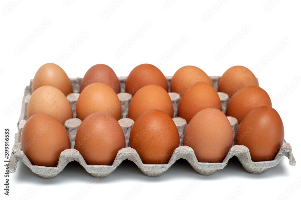 Brown raw chicken eggs in a cardboard box for eggs.Food background. Brown raw chicken eggs in a cardboard box for eggs.Food background.