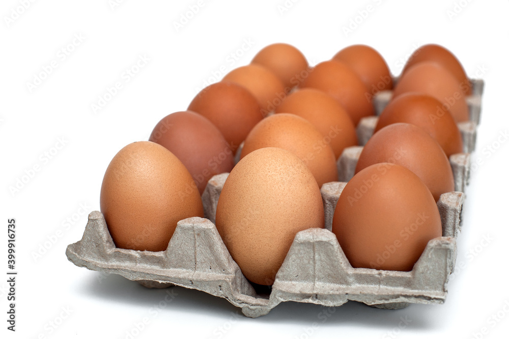 Brown raw chicken eggs in a cardboard box for eggs.Food background.