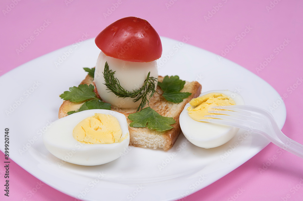 Sandwich with edible mushroom made of egg on pink background. Food art idea for children. Kid’s breakfast.